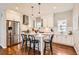 Bright, modern kitchen with stainless steel appliances, a center island, and hardwood floors at 130 S Corona St, Denver, CO 80209