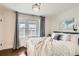 Calming main bedroom featuring hardwood floors, ample natural light, and neutral decor at 130 S Corona St, Denver, CO 80209