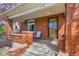 Cozy front porch with red brick columns, a rocking chair, and a secure front door at 130 S Corona St, Denver, CO 80209