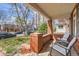 Inviting covered porch with red brick, comfortable seating, and neighborhood views at 130 S Corona St, Denver, CO 80209