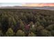 Breathtaking aerial view of a wooded property with mountain views at sunset at 18045 Arrowwood Dr, Monument, CO 80132