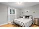 Cozy bedroom featuring hardwood floors, a metal bed frame, and bright natural light at 18045 Arrowwood Dr, Monument, CO 80132