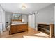 Bedroom with wood floors, barn door, and a window that allows natural light to stream in at 18045 Arrowwood Dr, Monument, CO 80132