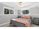 Basement bedroom featuring a bed, two nightstands, and views of surrounding trees at 18045 Arrowwood Dr, Monument, CO 80132