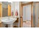 This bathroom features a pedestal sink and separate shower at 11683 Pointe View Dr, Longmont, CO 80503