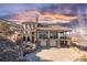 Spectacular view of the exterior elevation of the home with sunset in background at 11683 Pointe View Dr, Longmont, CO 80503