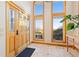 Sun-drenched foyer with tile floors, large windows, and solid wood front door at 11683 Pointe View Dr, Longmont, CO 80503