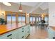 Kitchen island with wood countertop, tile floor, and access to an outdoor living area at 11683 Pointe View Dr, Longmont, CO 80503