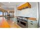 Open kitchen boasts stainless steel appliances, tile backsplash, and access to an outdoor living space at 11683 Pointe View Dr, Longmont, CO 80503