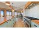 This kitchen features an island with wood countertop, stainless appliances, and access to outdoor living at 11683 Pointe View Dr, Longmont, CO 80503