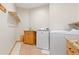Functional laundry room with granite countertop and machines at 11683 Pointe View Dr, Longmont, CO 80503