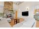 Grand living room with stone fireplace, high ceilings, and comfortable seating at 11683 Pointe View Dr, Longmont, CO 80503