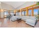 Spacious living room with vaulted ceilings, tile floors, and exterior access to a covered porch at 11683 Pointe View Dr, Longmont, CO 80503