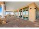Spacious covered patio featuring stone columns and multiple glass doors leading to the interior at 11683 Pointe View Dr, Longmont, CO 80503
