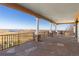 Covered patio with stone columns and beautiful views of the surrounding landscape at 11683 Pointe View Dr, Longmont, CO 80503