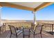 Covered patio with comfortable seating and scenic views of the lake and landscape at 11683 Pointe View Dr, Longmont, CO 80503