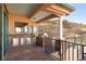Covered patio with stone columns, outdoor kitchen, and stainless steel cabinets at 11683 Pointe View Dr, Longmont, CO 80503