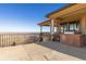 Outdoor patio with stone columns and outdoor kitchen with a stunning view of the landscape at 11683 Pointe View Dr, Longmont, CO 80503