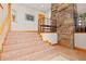 Beautiful staircase with tile steps, wooden trim, and stone accent wall at 11683 Pointe View Dr, Longmont, CO 80503