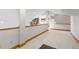 Open upper level landing area with stone accent wall and wood trim at 11683 Pointe View Dr, Longmont, CO 80503
