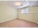 Finished basement room with a window and drop ceiling at 2893 S Joslin Ct, Denver, CO 80227