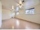 Well-lit basement space with two windows, drop ceiling, and ceiling fans at 2893 S Joslin Ct, Denver, CO 80227