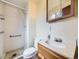 Bathroom with walk-in shower, vanity, and mirror at 2893 S Joslin Ct, Denver, CO 80227
