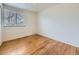 Modest bedroom with hardwood floors and a window allowing natural light at 2893 S Joslin Ct, Denver, CO 80227