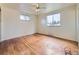Bright bedroom with hardwood floors, a ceiling fan, and two windows allowing natural light at 2893 S Joslin Ct, Denver, CO 80227