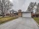 Wide driveway leading to a brick home with an attached garage, perfect for multiple vehicles at 2893 S Joslin Ct, Denver, CO 80227
