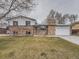 Charming two-story brick home featuring an attached garage and well-maintained front yard at 2893 S Joslin Ct, Denver, CO 80227