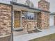 Close-up of the home's front entrance, showcasing the brick facade and covered entryway at 2893 S Joslin Ct, Denver, CO 80227