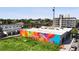 Urban view of a neighborhood with colorful murals, modern buildings, and city skyline in distance at 1519 E 29Th Ave, Denver, CO 80205