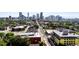 Urban view featuring a street, buildings, and the downtown Denver skyline in the background at 1519 E 29Th Ave, Denver, CO 80205