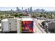 A vibrant cityscape mural on a building, surrounded by lush greenery and modern architecture at 1519 E 29Th Ave, Denver, CO 80205