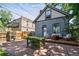 Charming backyard featuring a patio, wooden deck, outdoor seating, grill, and a beautiful brick house at 1519 E 29Th Ave, Denver, CO 80205