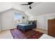 Bright attic bedroom with a large window, neutral walls, and a decorative rug at 1519 E 29Th Ave, Denver, CO 80205
