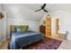 Inviting bedroom with light wood floors, a bed with colorful pillows, and a classic wood dresser at 1519 E 29Th Ave, Denver, CO 80205