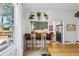 Bright dining area featuring woven stools at a breakfast bar, leafy green plants, and view of kitchen at 1519 E 29Th Ave, Denver, CO 80205