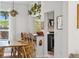 Stylish dining area with natural wood table, woven chairs, pendant light, and kitchen view at 1519 E 29Th Ave, Denver, CO 80205