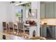 Charming dining area with woven chairs, a countertop bar, and a view into the kitchen at 1519 E 29Th Ave, Denver, CO 80205