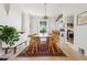 Bright dining room with wood table, pendant light, and a view to the kitchen at 1519 E 29Th Ave, Denver, CO 80205