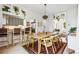 Bright dining room with a view to the kitchen, wood table and modern light fixture at 1519 E 29Th Ave, Denver, CO 80205