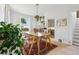 Dining room with natural light, stylish light fixture, wood table, and access to kitchen at 1519 E 29Th Ave, Denver, CO 80205
