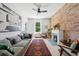 Bright living room with exposed brick wall, fireplace, and hardwood floors at 1519 E 29Th Ave, Denver, CO 80205