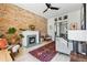 Bright living room featuring a fireplace, exposed brick wall and light colored wood floors at 1519 E 29Th Ave, Denver, CO 80205
