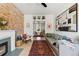 Bright living room and open concept dining area with brick wall fireplace at 1519 E 29Th Ave, Denver, CO 80205