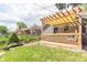 Inviting backyard with a pergola-covered deck, lush lawn, and charming garden beds at 3325 Irving St, Denver, CO 80211