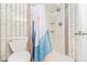 Modern bathroom with tiled shower, stylish shower curtain and toilet at 3325 Irving St, Denver, CO 80211