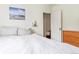 Neutral bedroom featuring white walls, shelving and a minimalist aesthetic at 3325 Irving St, Denver, CO 80211